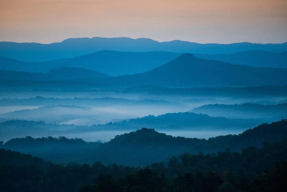 The mountains on the Blue Ridge Parkway welcome the morning with light and mist. Fog is forming in the valley as the sun comes up lighting up the day. Enjoye!