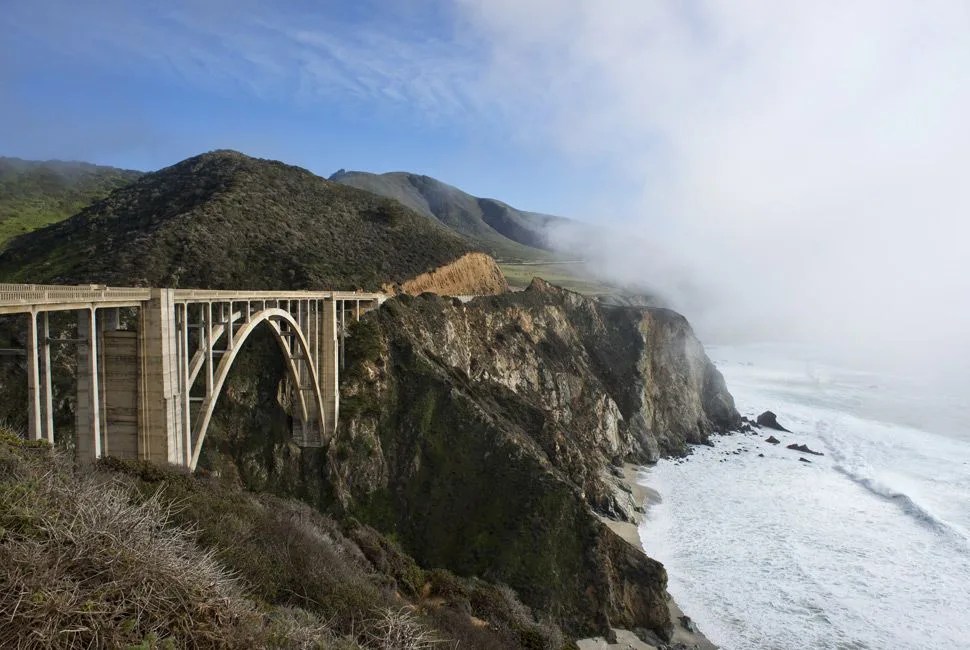 Beautiful Bixby Bridge Big Sur California fog hanging along the edge of Hwy 1