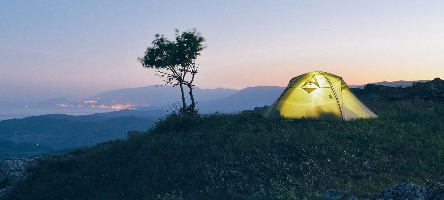 Night landscape with tourist tent. Camping in the mountains