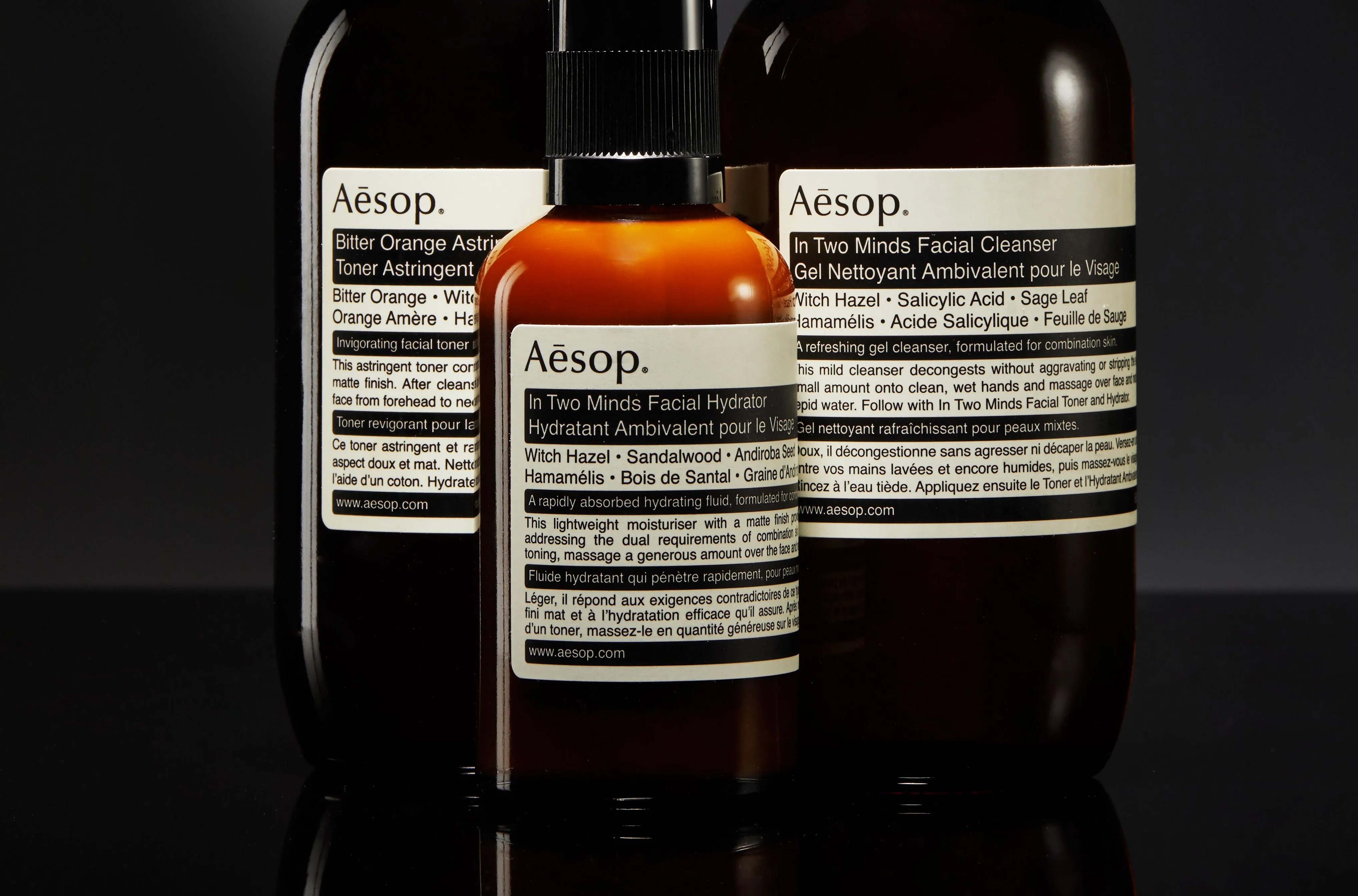 three bottles of aesop grooming products