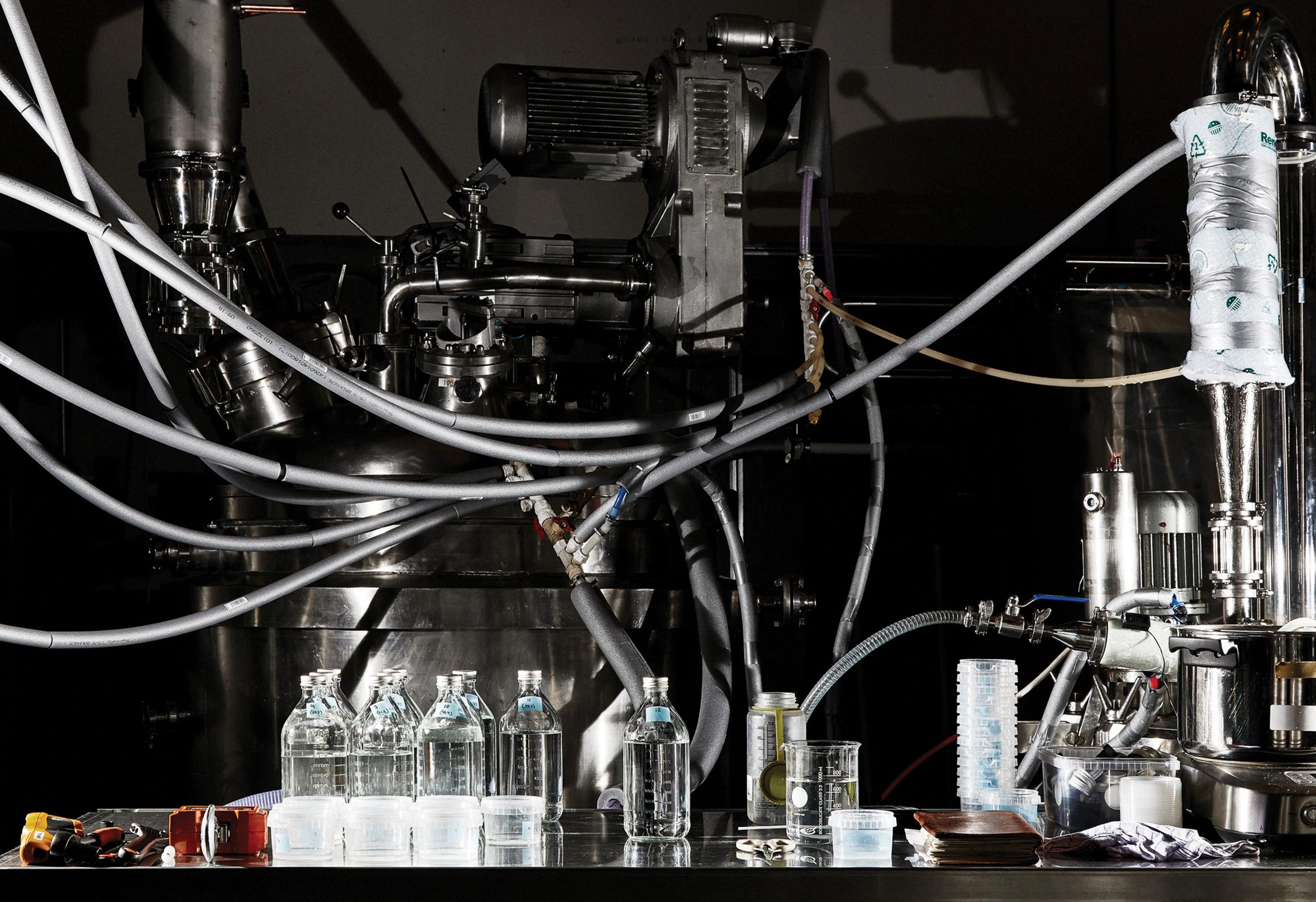 various tubes leading to different machines and bottles, used for distilling alcohol