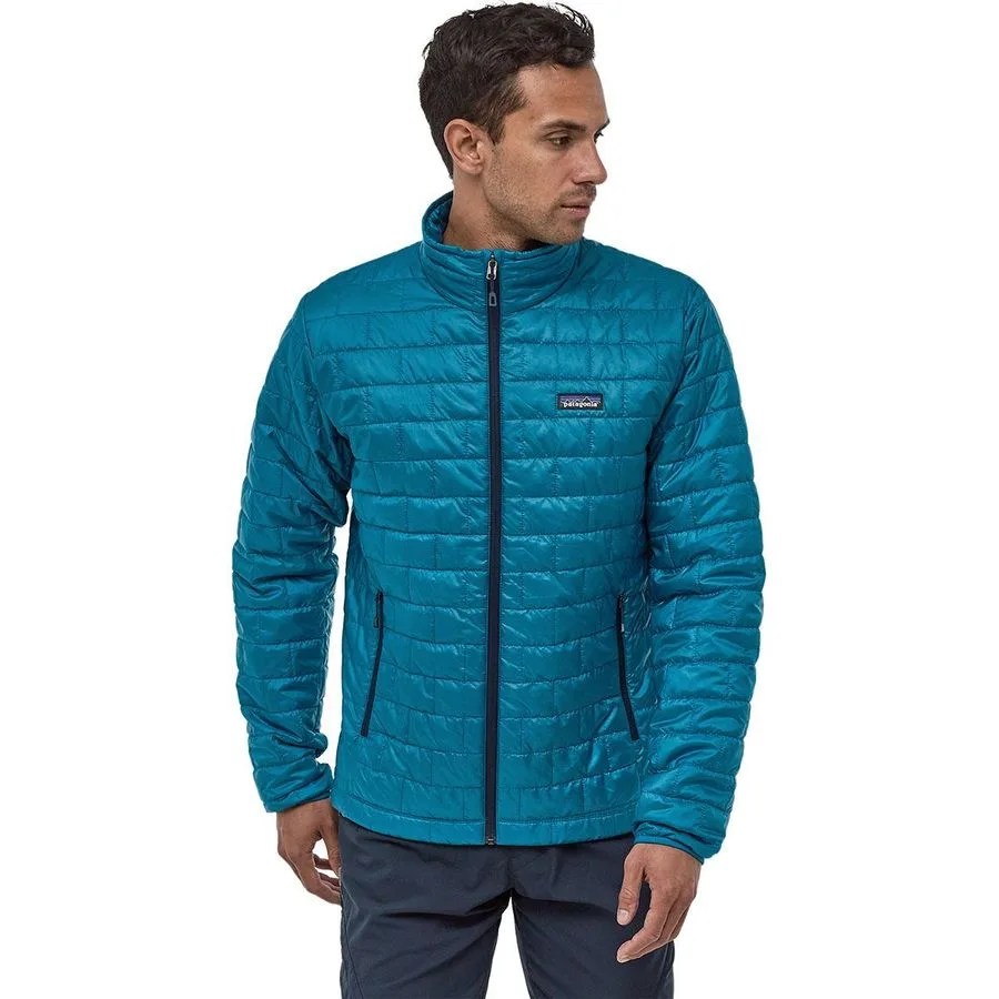 A light blue Patagonia puffy jacket on a model with blue pants.