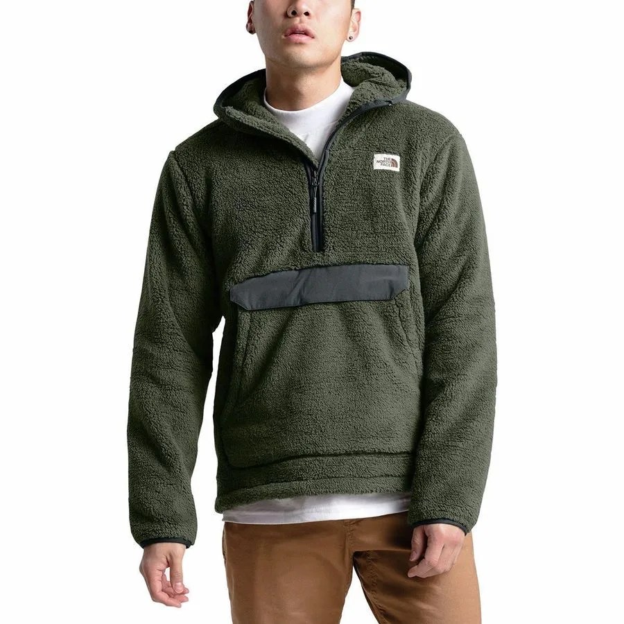 A green fleece hoodie on a model on a gray background.