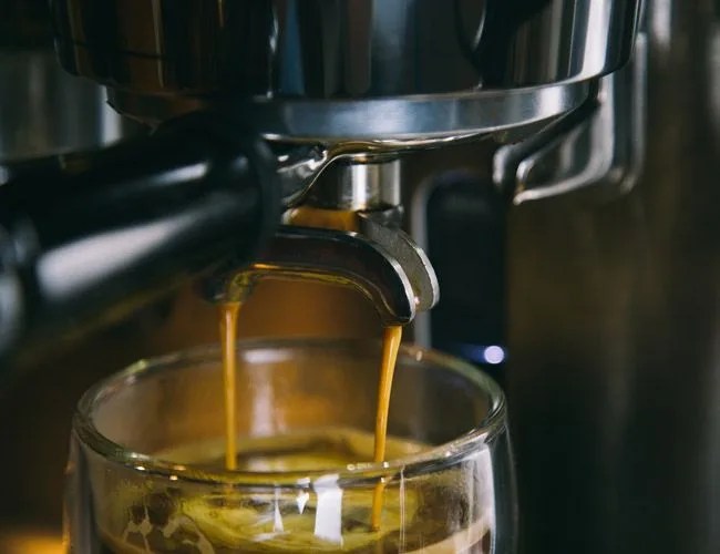 espresso being made and pouring into a cup