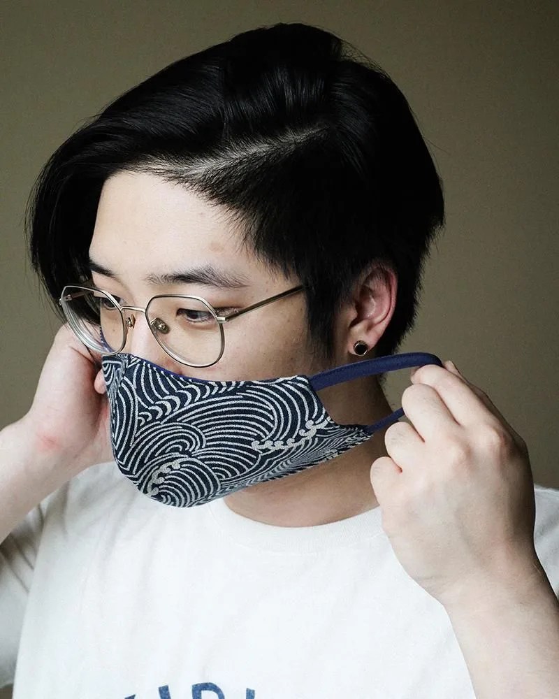 model wearing blue and white face mask