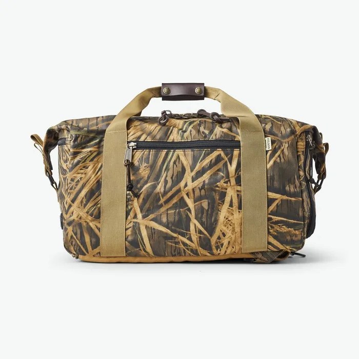 A camo duffel bag on a gray background.