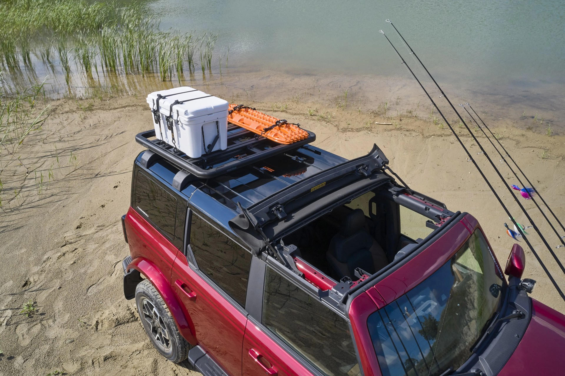 bronco four door outer banks fishing guide purpose built to support a professional fishing guide along cape hatteras national seashore, this lifestyle concept is based off the regionally inspired four door bronco outer banks&trade; series on top is a bestop&reg; sunrider&reg; first row soft top, factory style concept roof rails and crossbars, and a yakima&reg; locknload&trade; platform roof rack the suv makes use of fender mounted trail sights to fit a custom made fishing pole and seat perch to wait for the perfect catch a ford performance modular front bumper and safari bar help push through rugged terrain, while a slide out tailgate provides a great work surface when repairing fishing rods or stringing up new lures all weather floor mats and splash guards round out the package preproduction image with optional features shown available beginning spring 2021 available late 2021