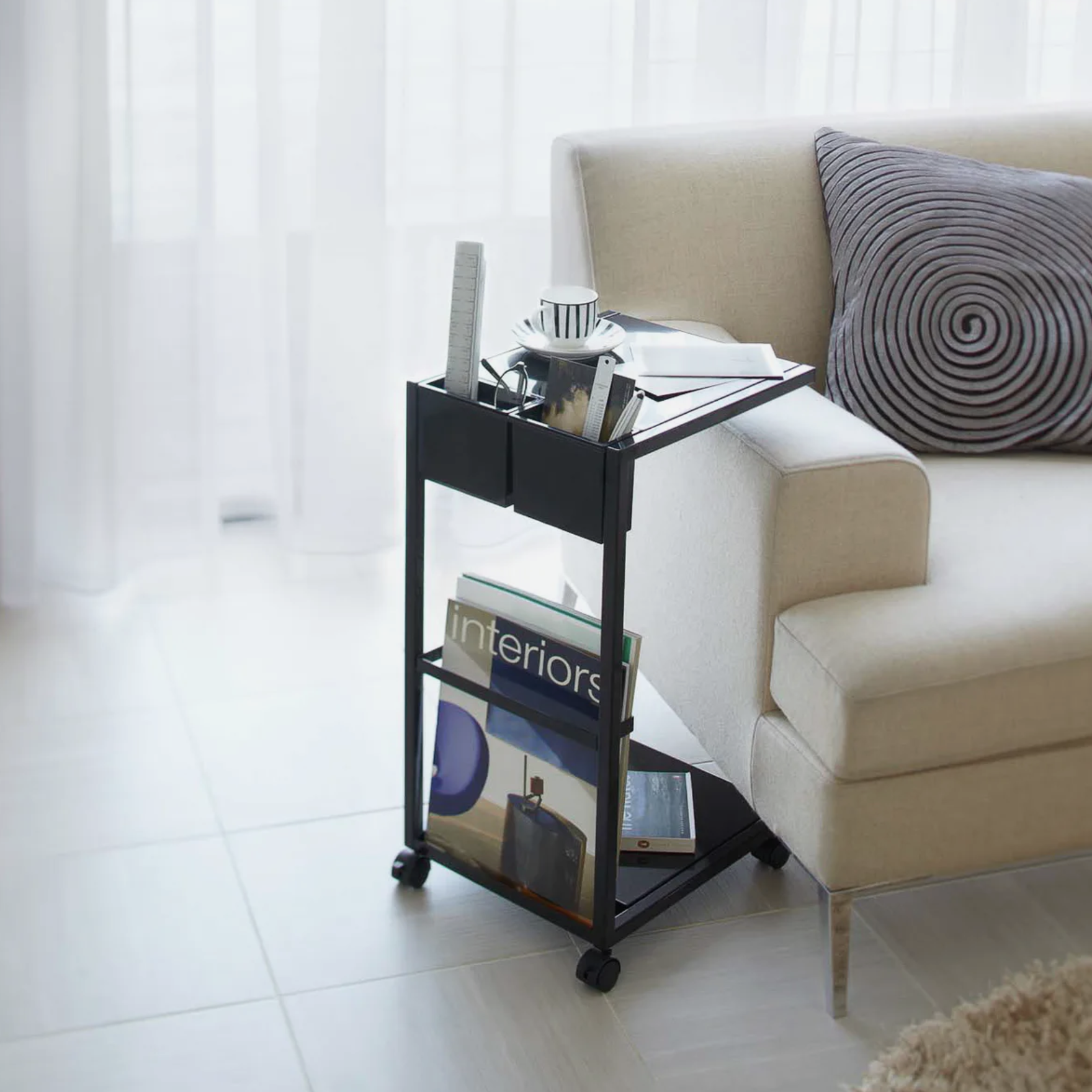 a living room set with a rolling side table and a couch