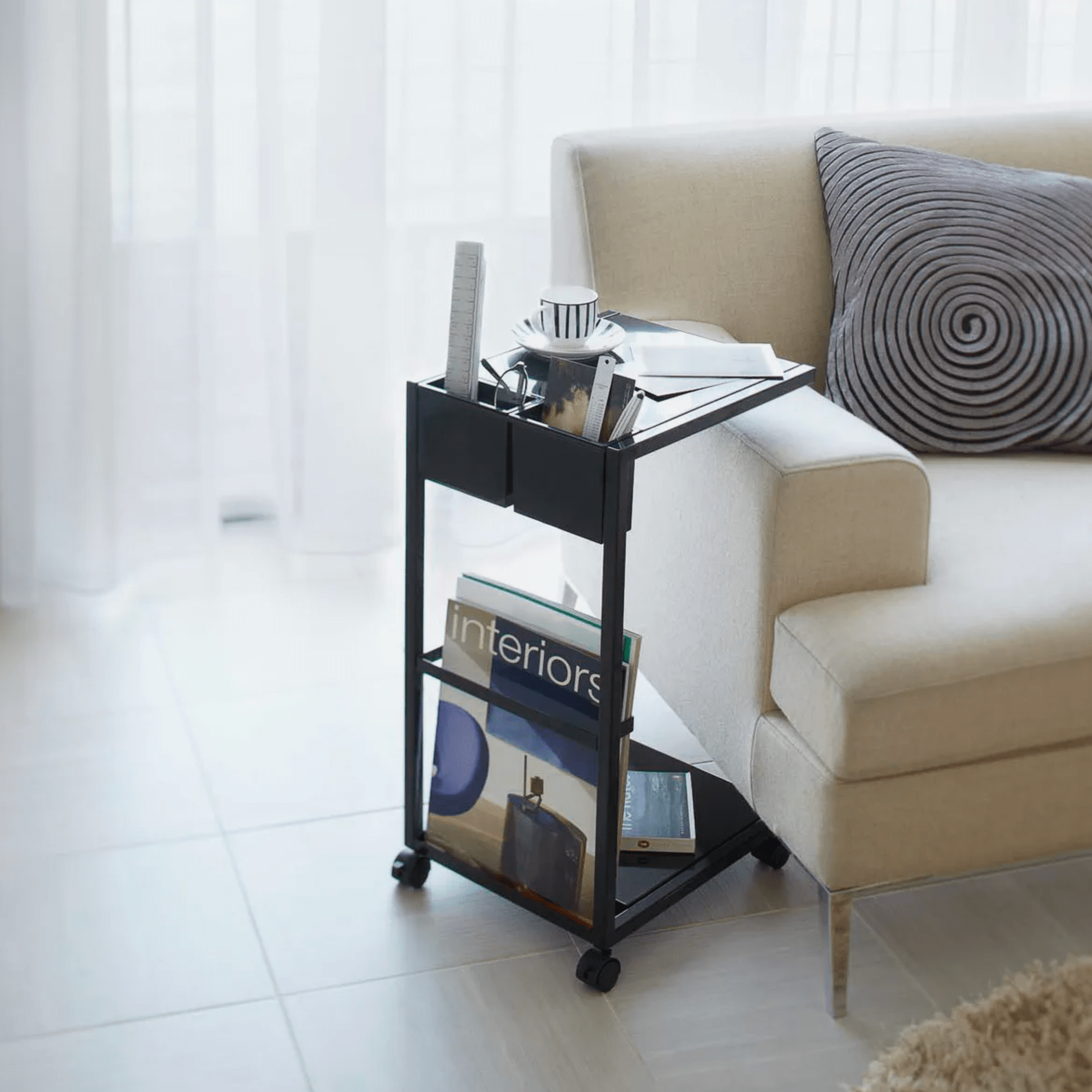 a living room set with a rolling side table and a couch