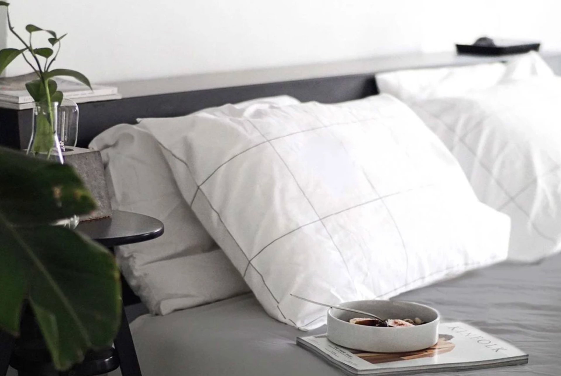 a bed with a gray duvet cover