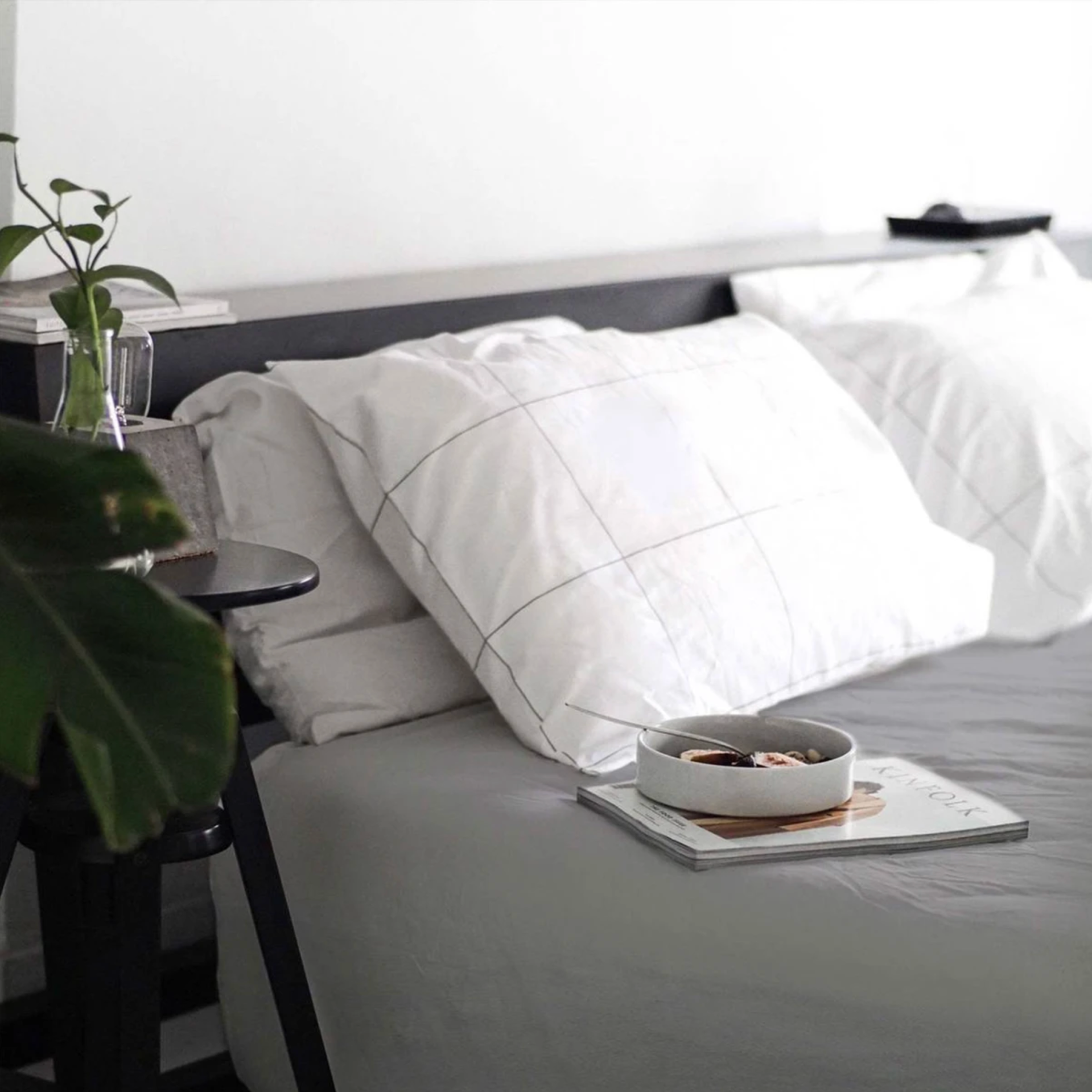 a bed with a gray duvet cover