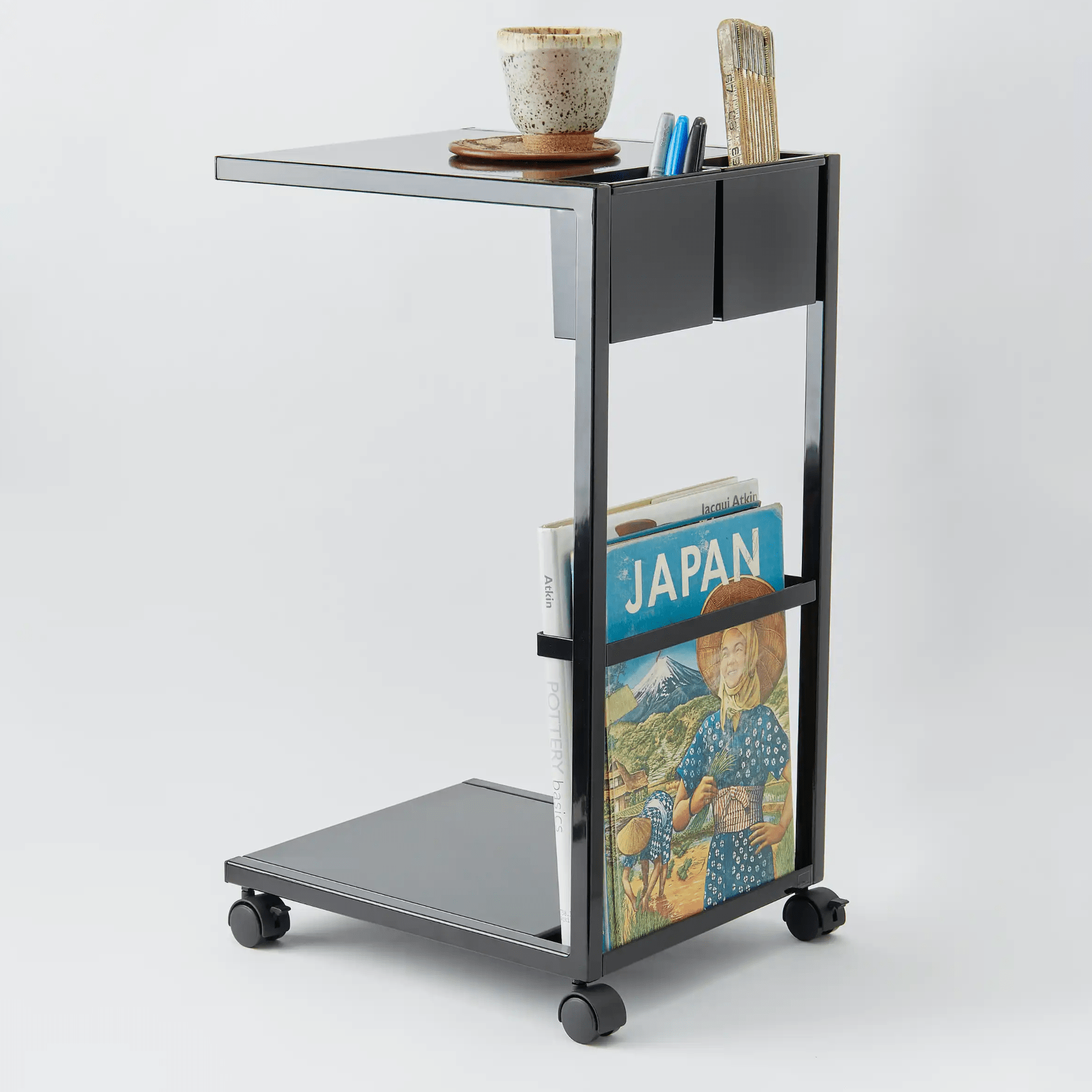 a side table on wheels on a gray background