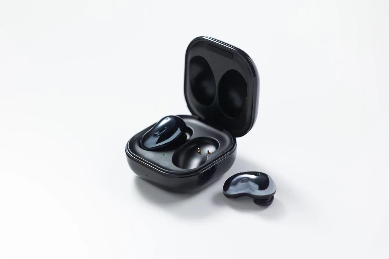 a pair of black samsung earbuds
