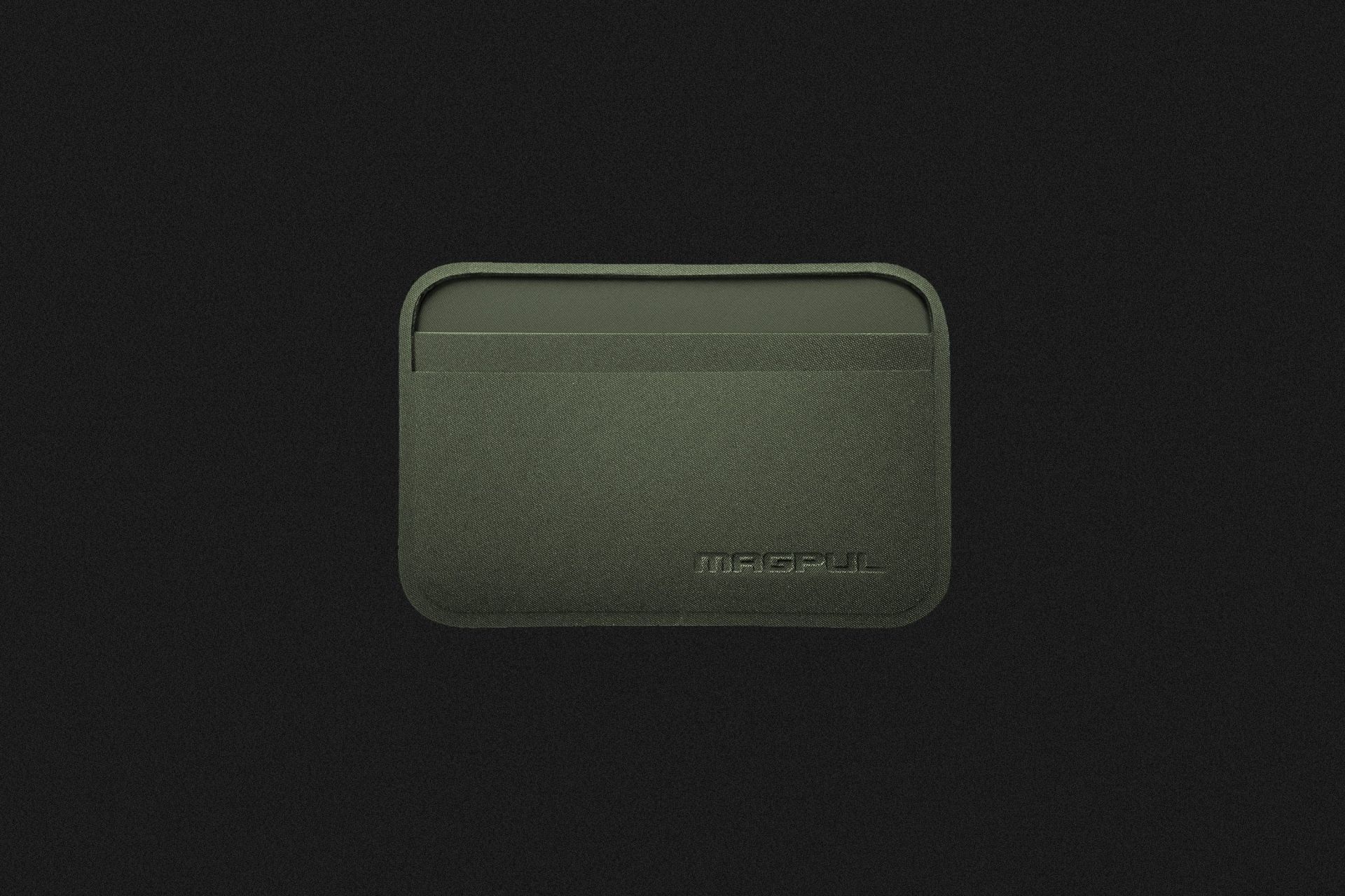 a thin green wallet on a black background
