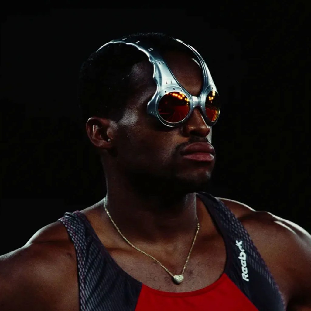 a black male athlete wearing unique silver sport glasses