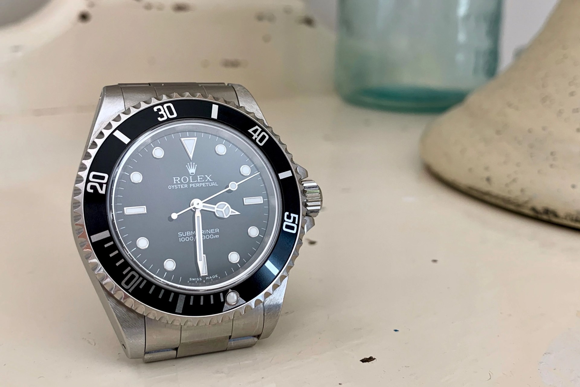 submariner watch on white table