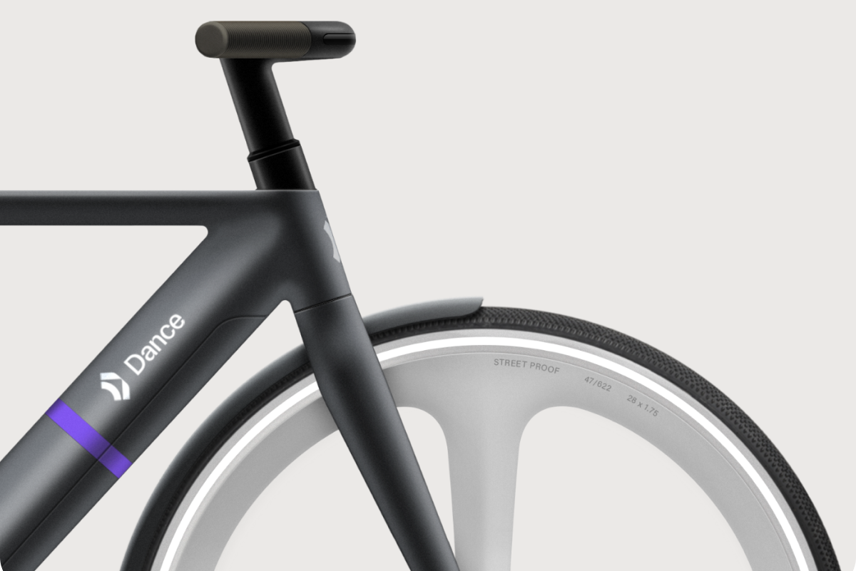 a close up of a black bike's handlebars and wheel