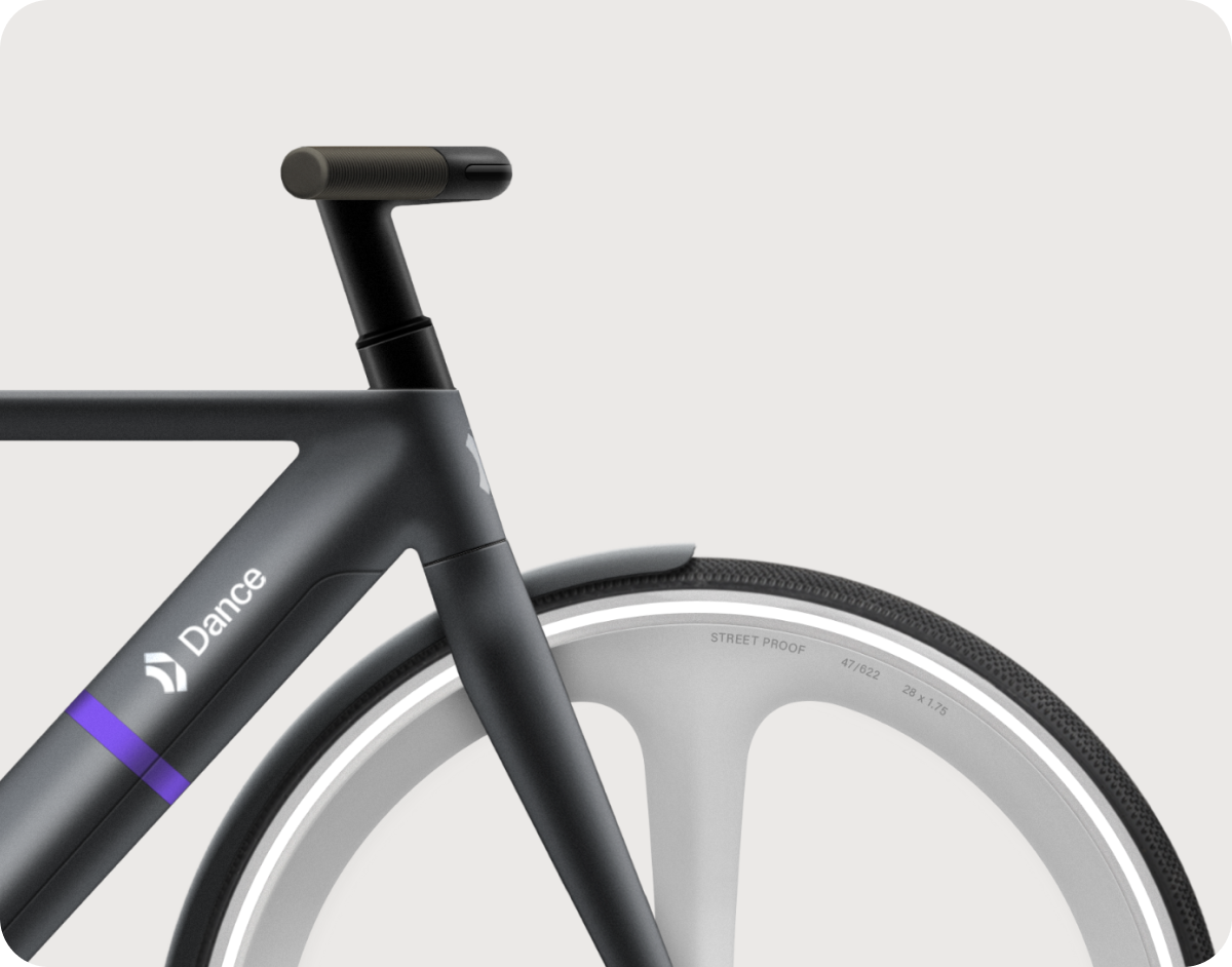 a close up of a black bike's handlebars and wheel