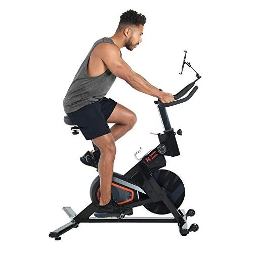 A model riding an exercise bike.