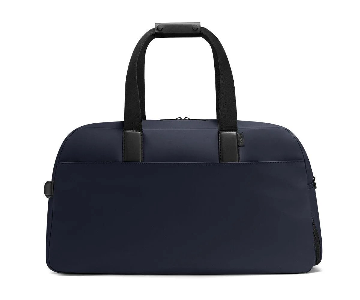 A navy blue weekend bag on a gray background.