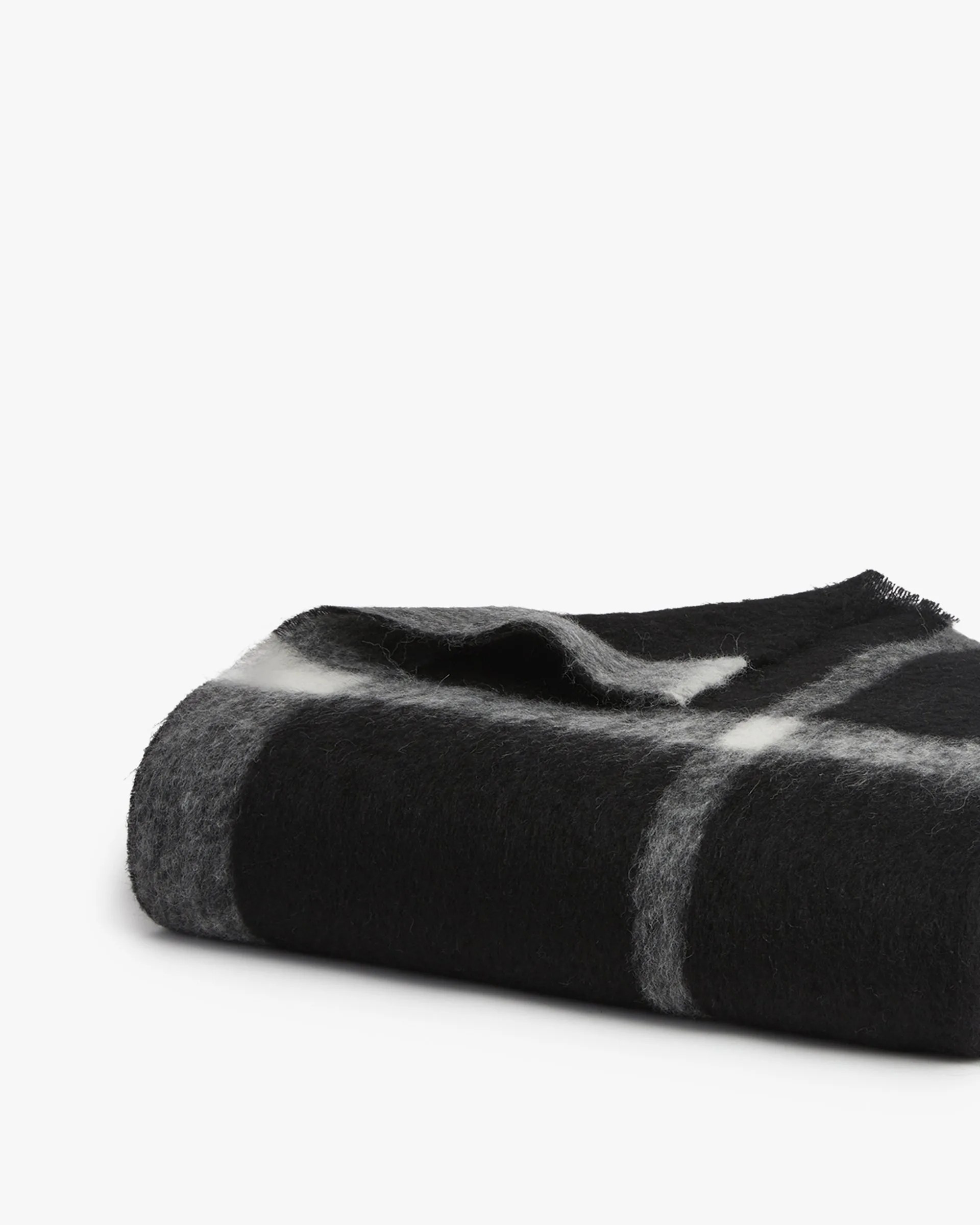 A black and white alpaca blanket on a gray background.