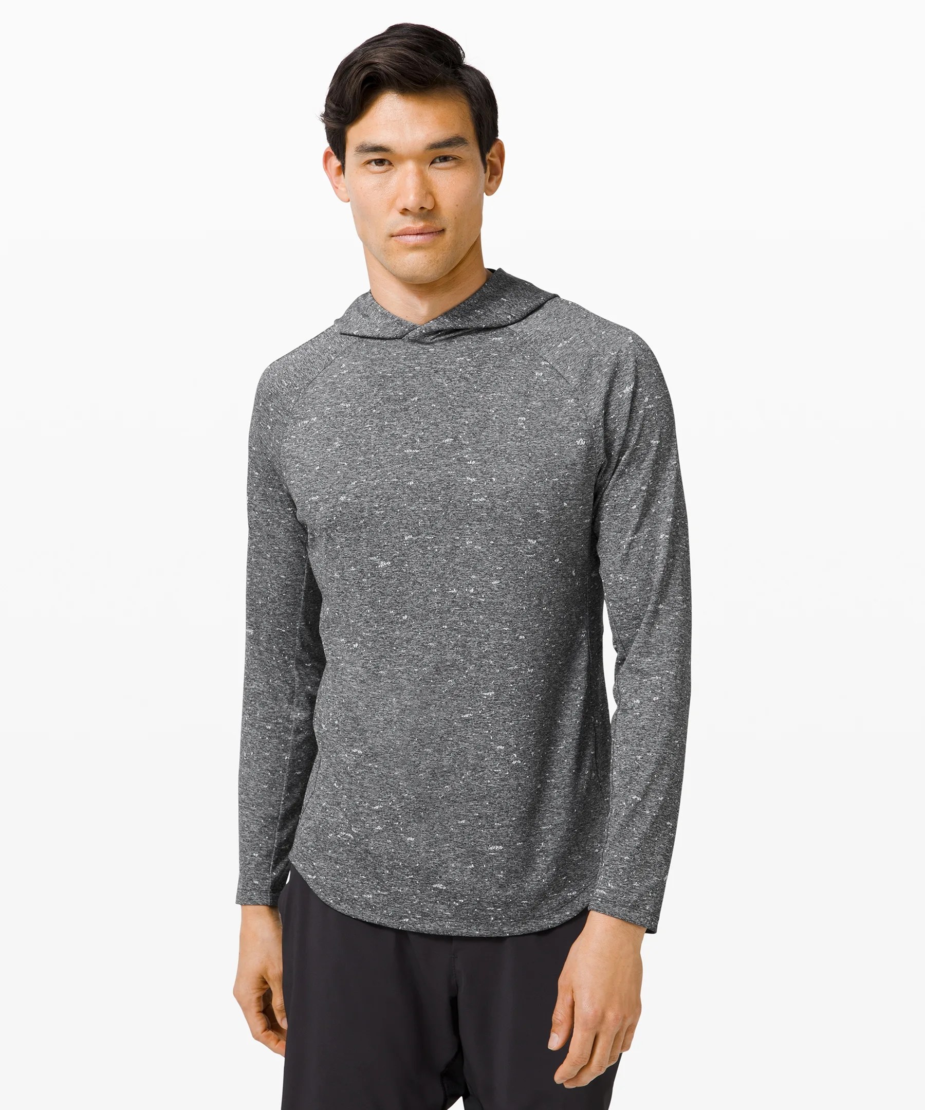 A model wearing and gray marbled hoodie on a gray background.