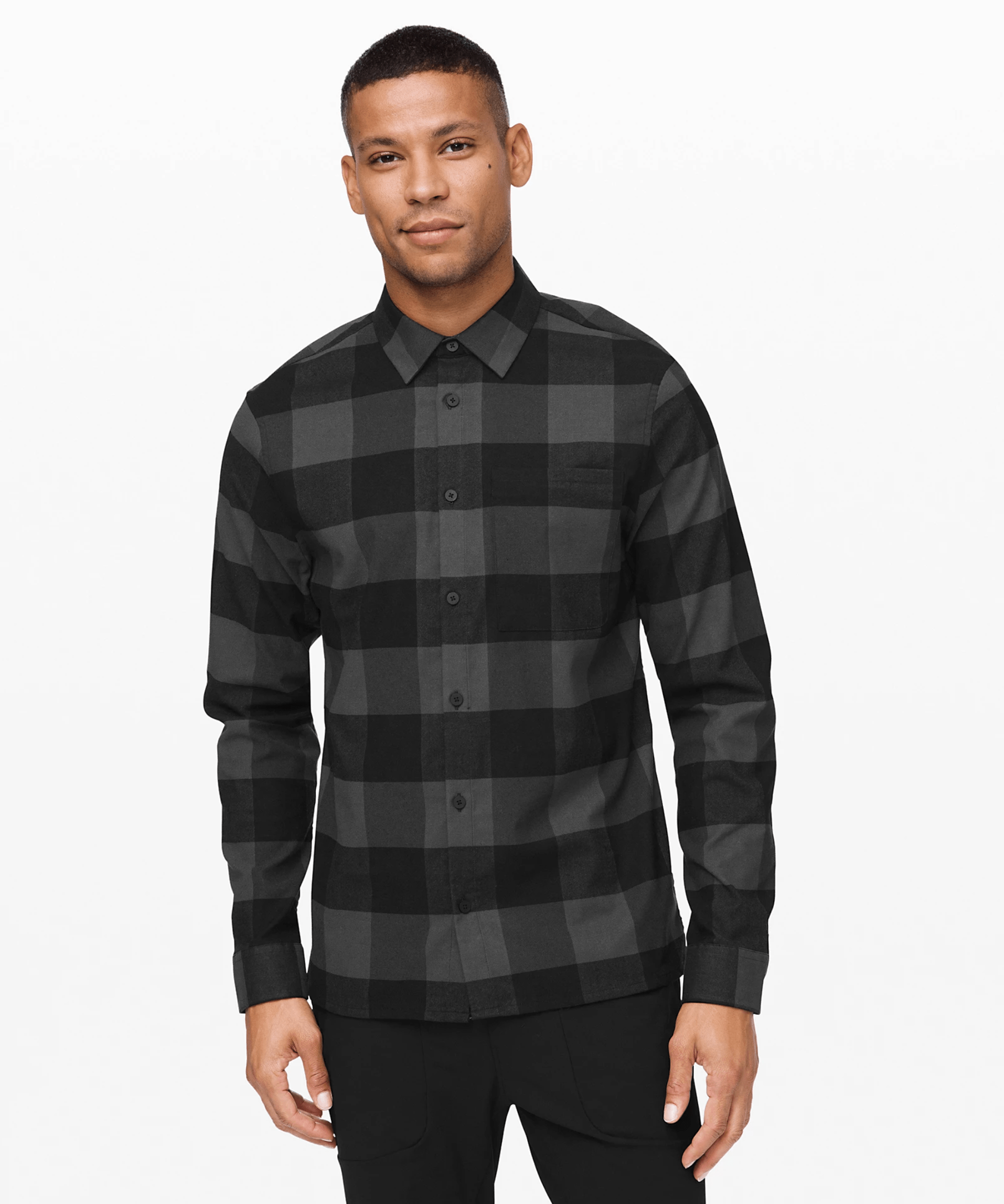 A model wearing a black checkered flannel shirt.