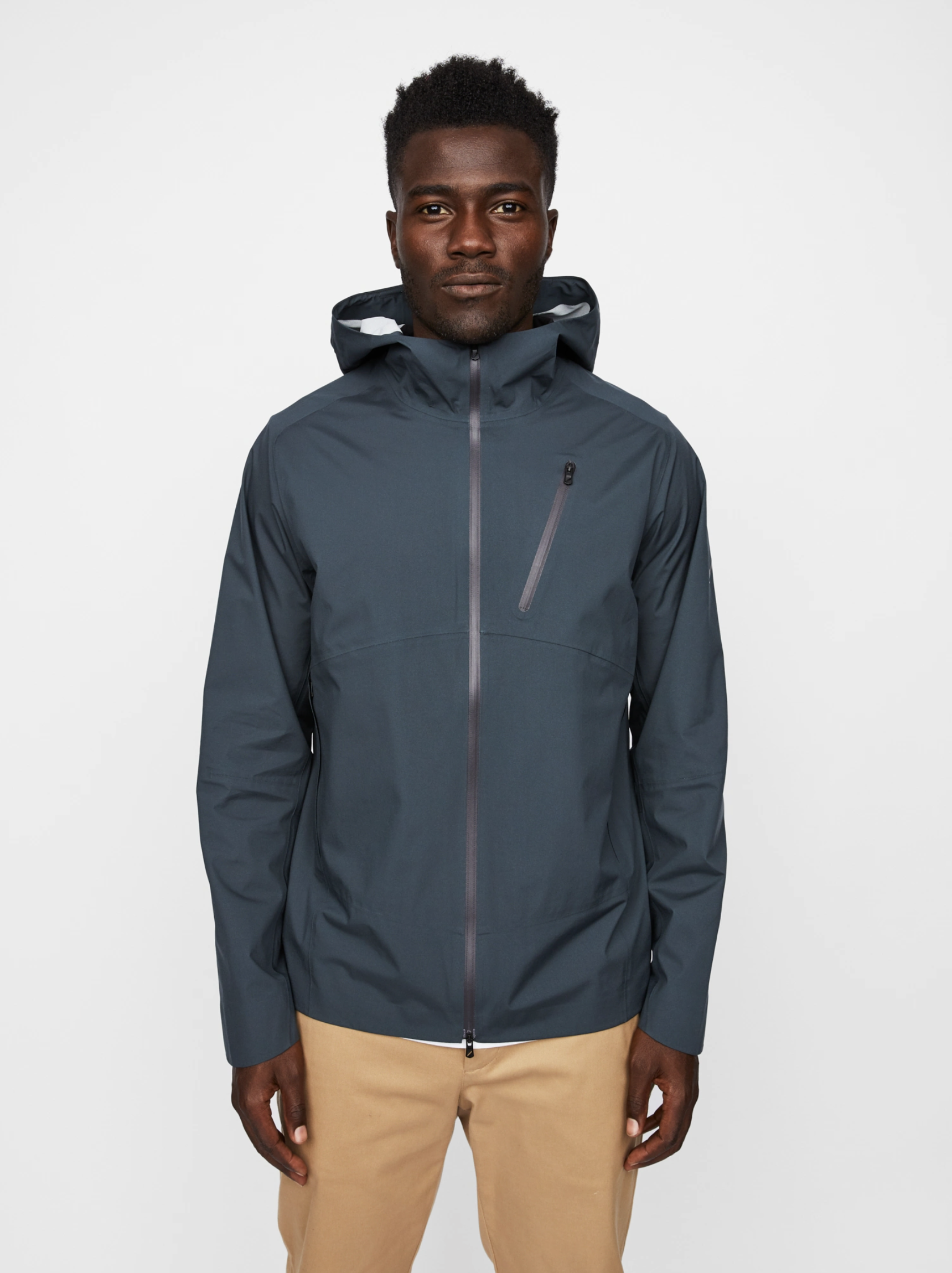 A model wearing a gray hooded rain jacket