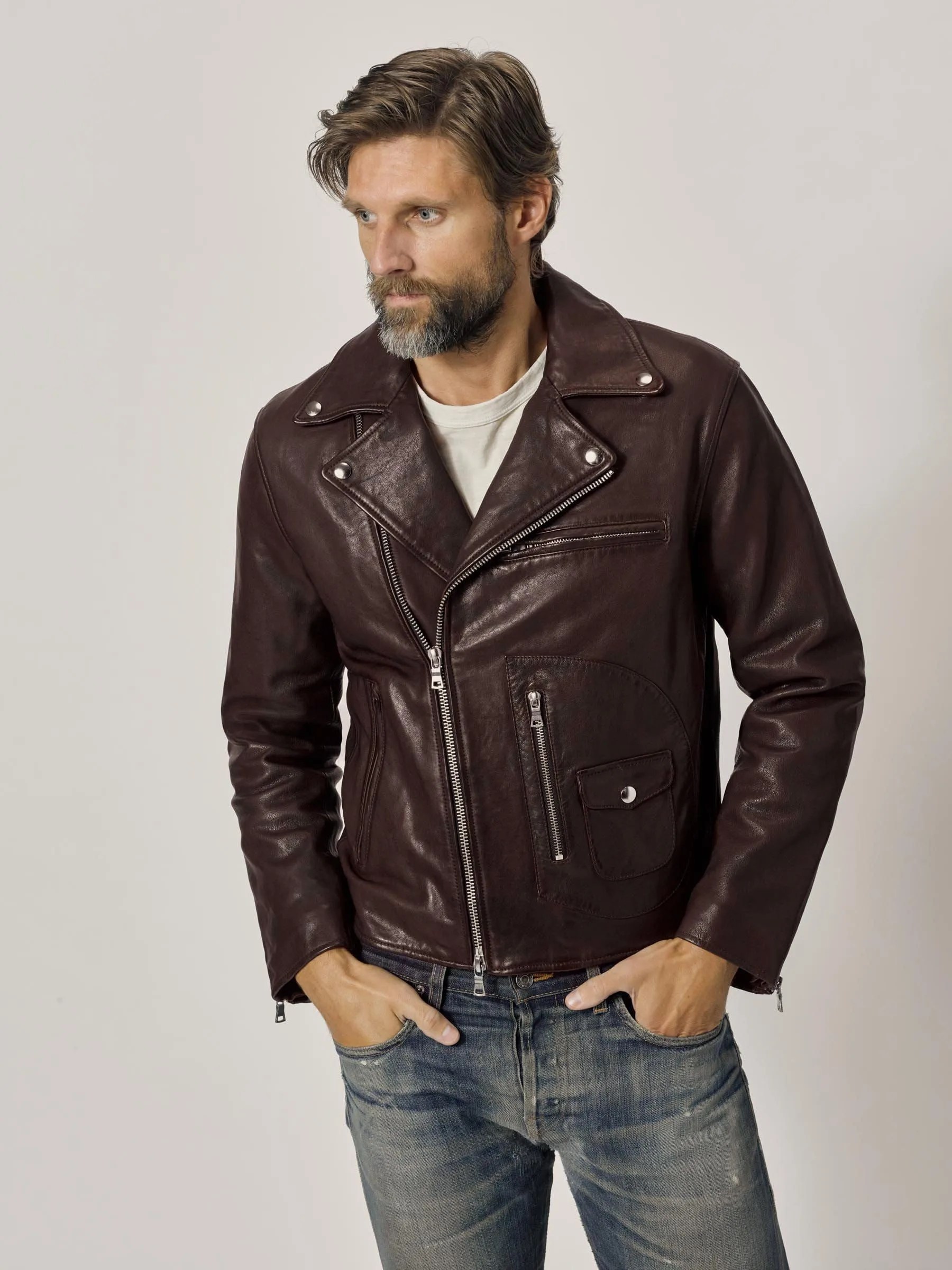 A model wearing a leather jacket, white t-shirt and jeans