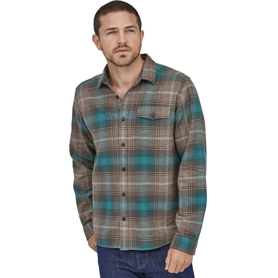 A model wearing a flannel shirt and jeans