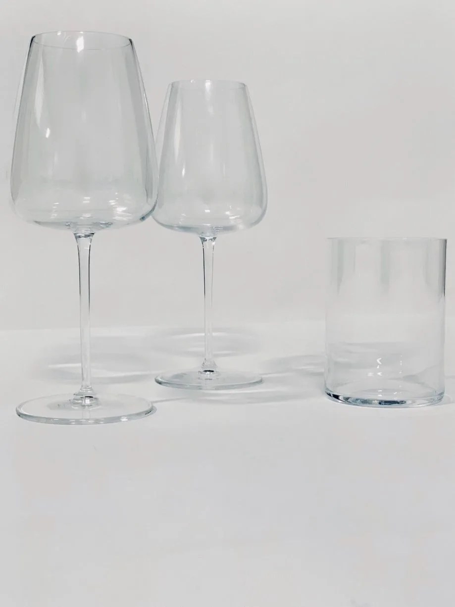 two wine glasses and a water glass