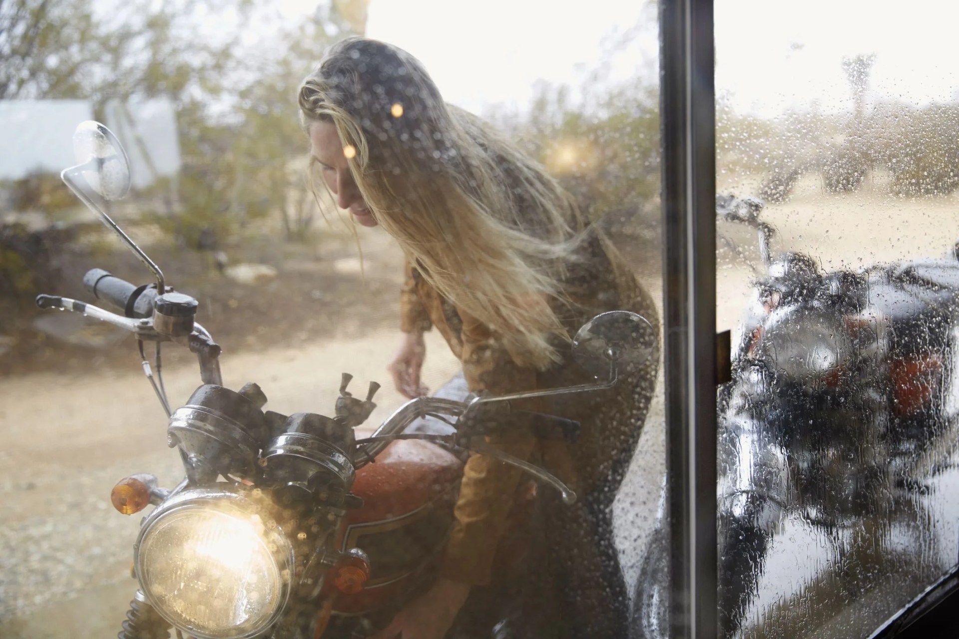 young woman getting ready for motorcycle ride
