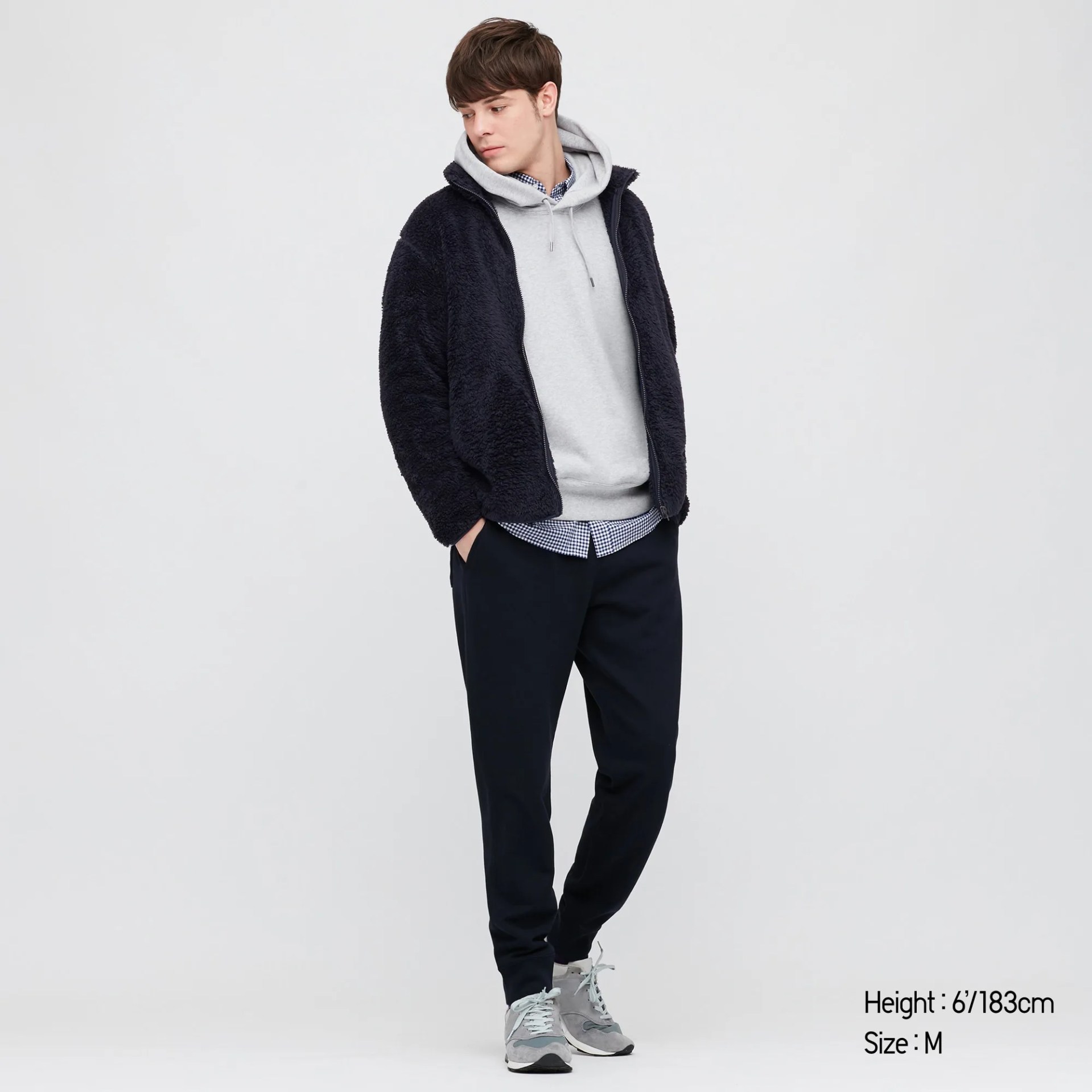 A model wearing a navy zip fleece jacket