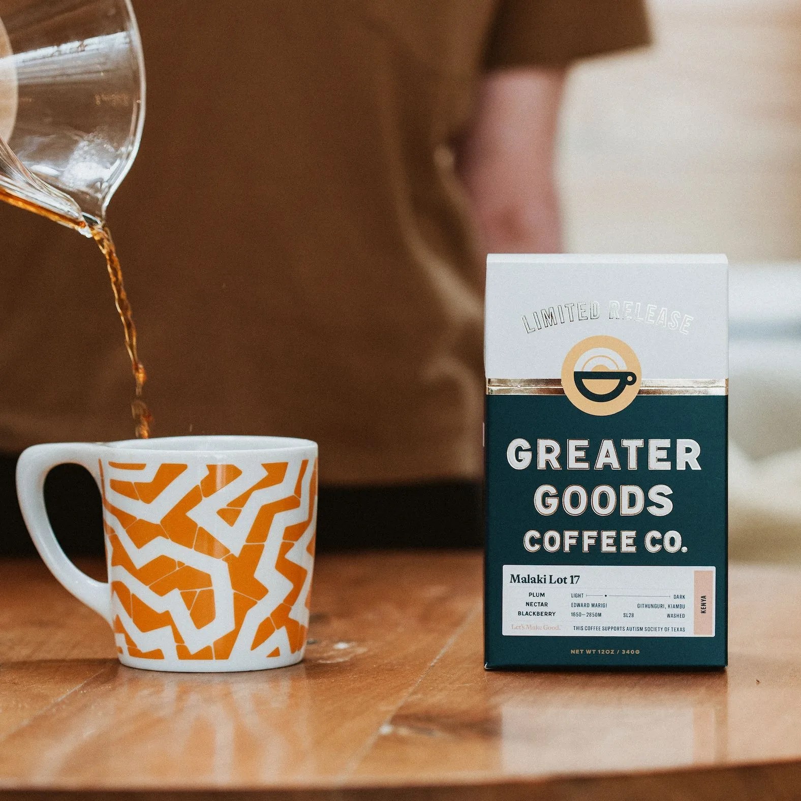pouring coffee into mug next to bag of coffee