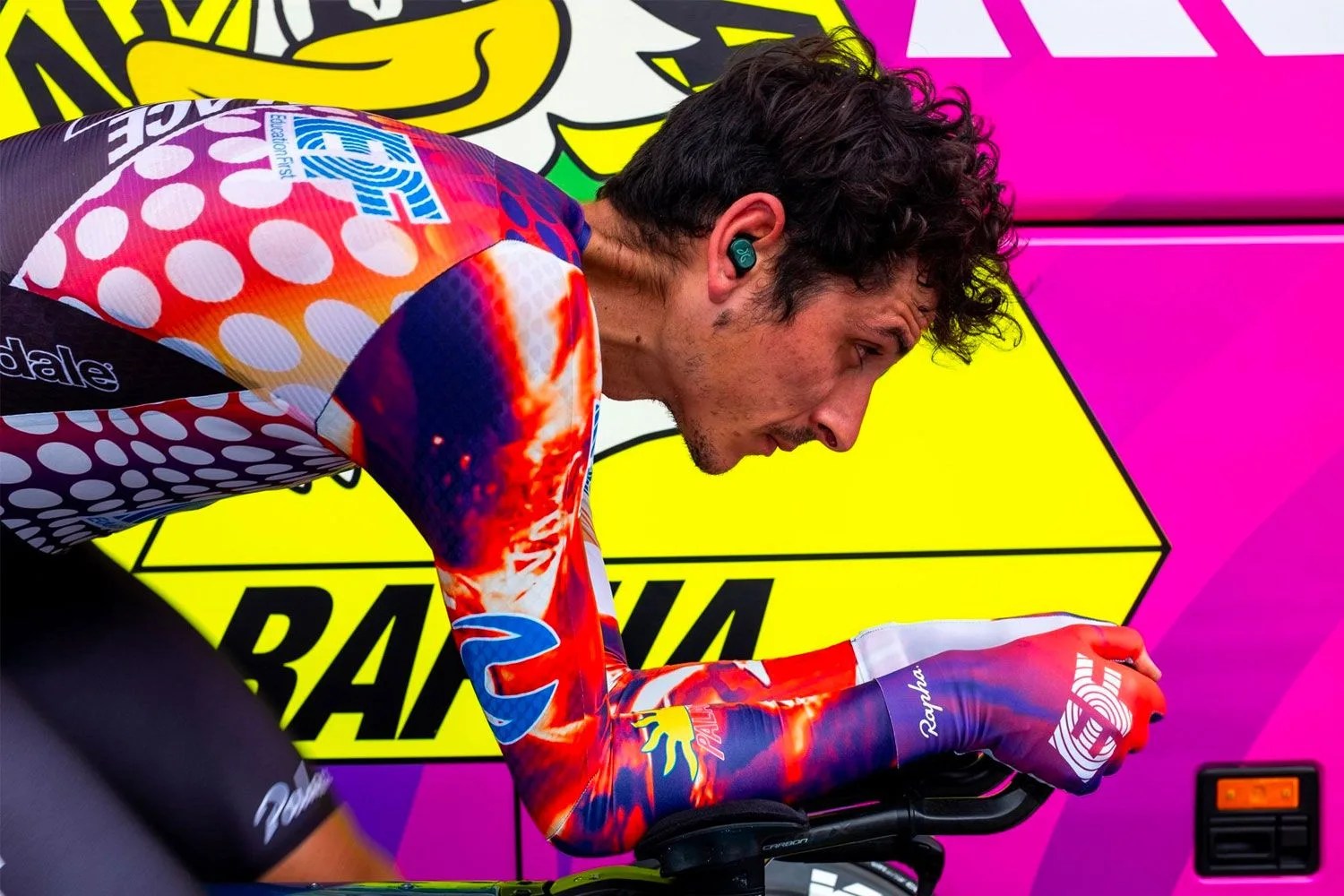 a man riding a bike wearing a colorful outfit