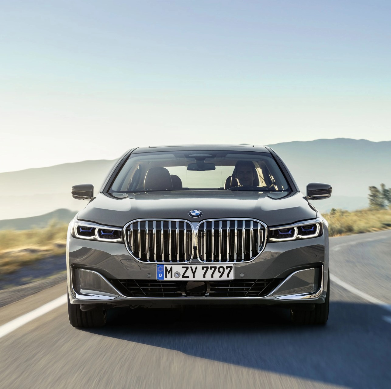 bmw 7 series sedan driving on road