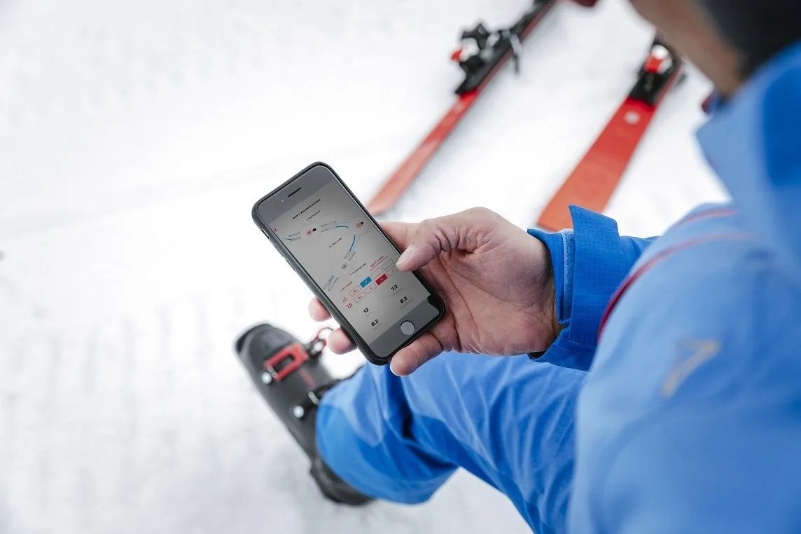a skier looking at his phone