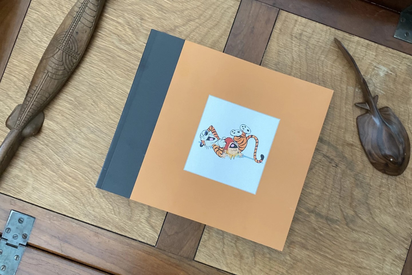 book in tray next to decorative objects