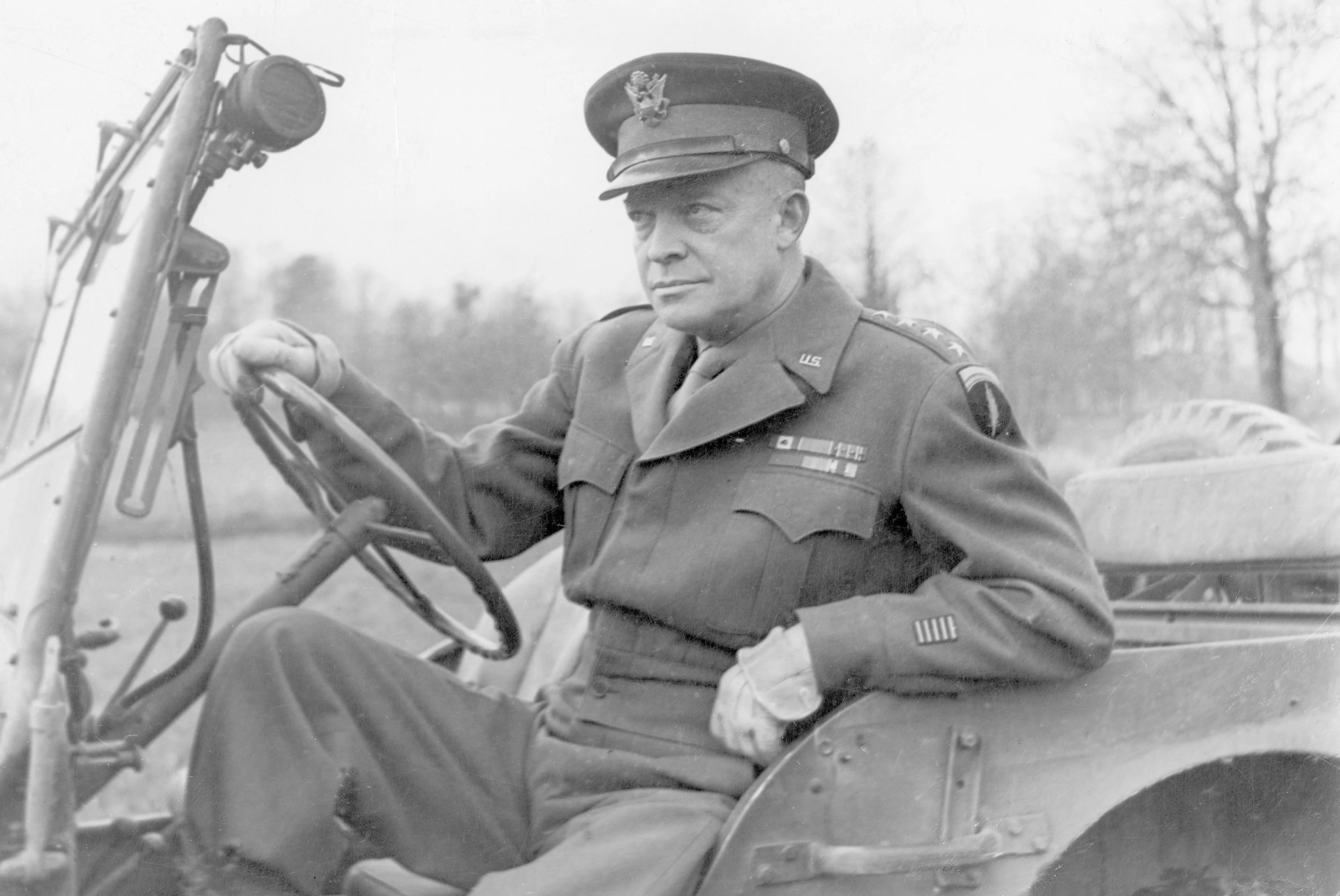 general dwight d eisenhower seated in a jeep on his way to deliver his christmas message the general called one soldier