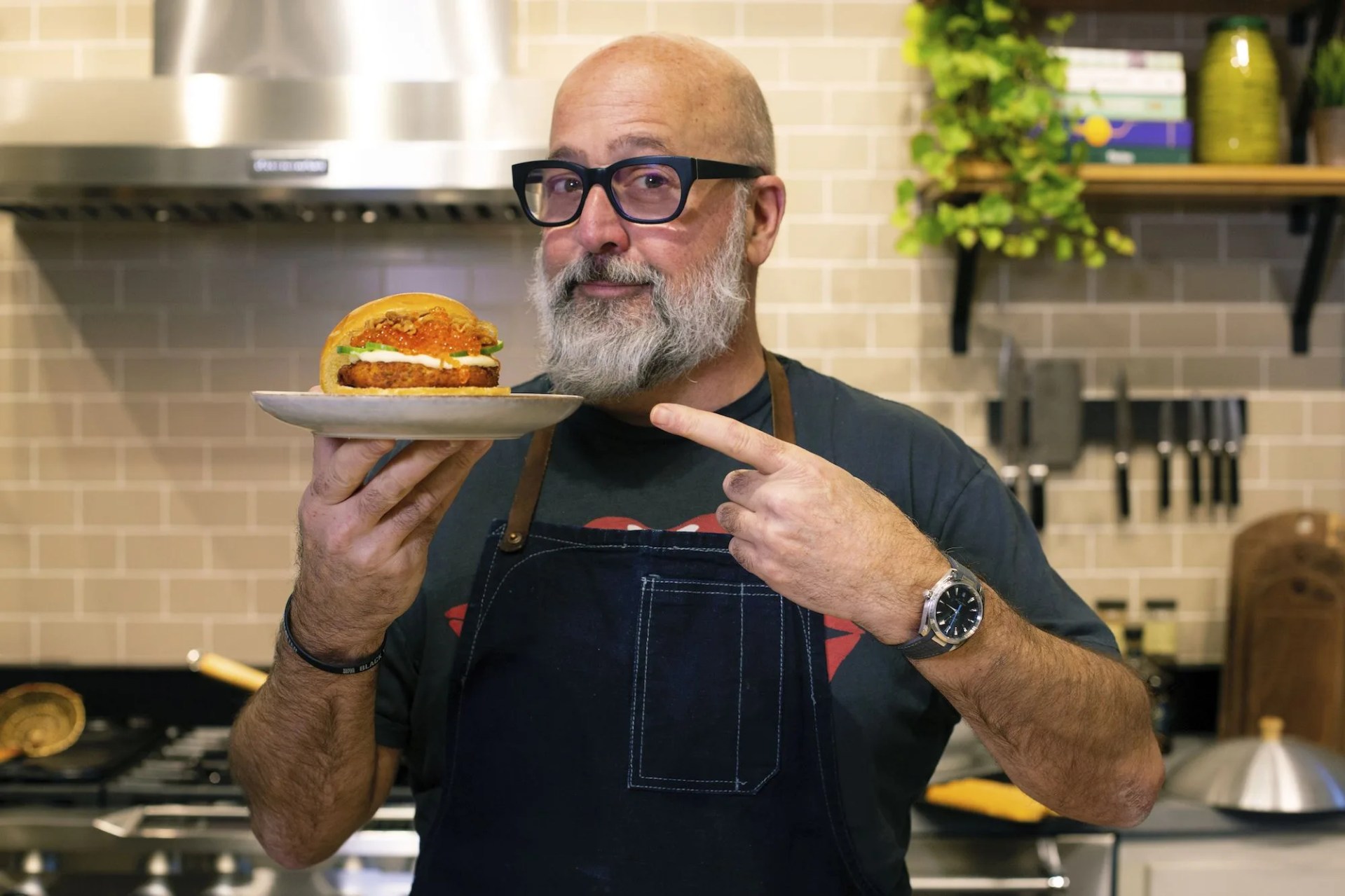 andrew zimmern holding salmon burger