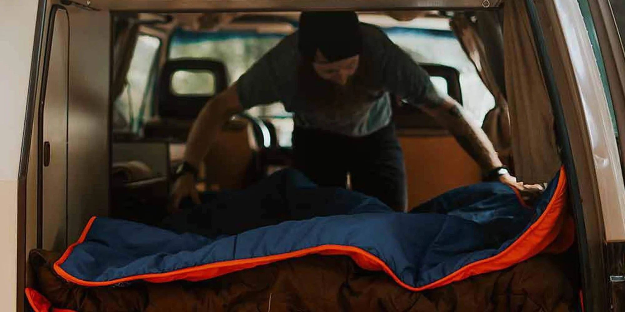 man setting up ignik heated blanket in car
