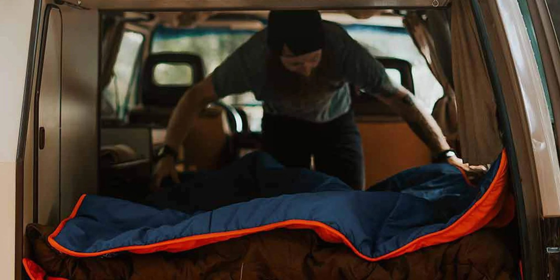 man setting up ignik heated blanket in car