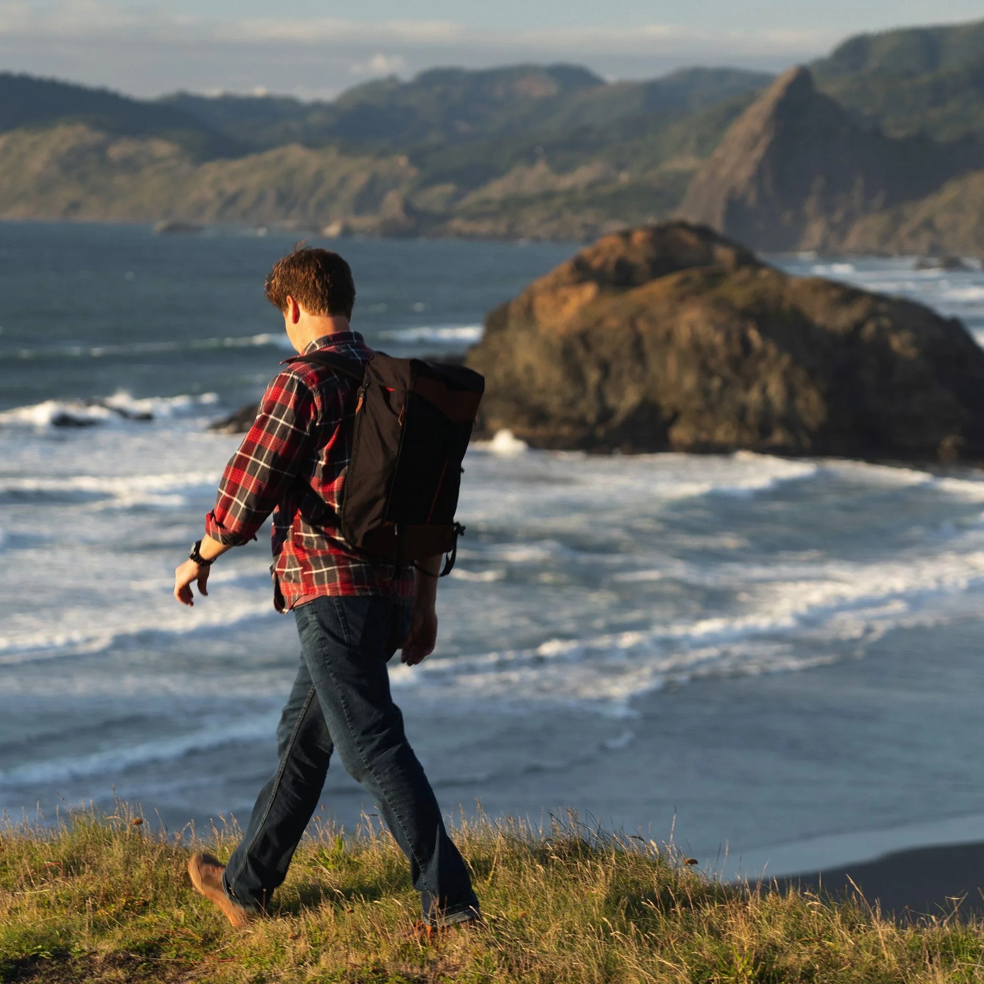 a man hiking near the ocean