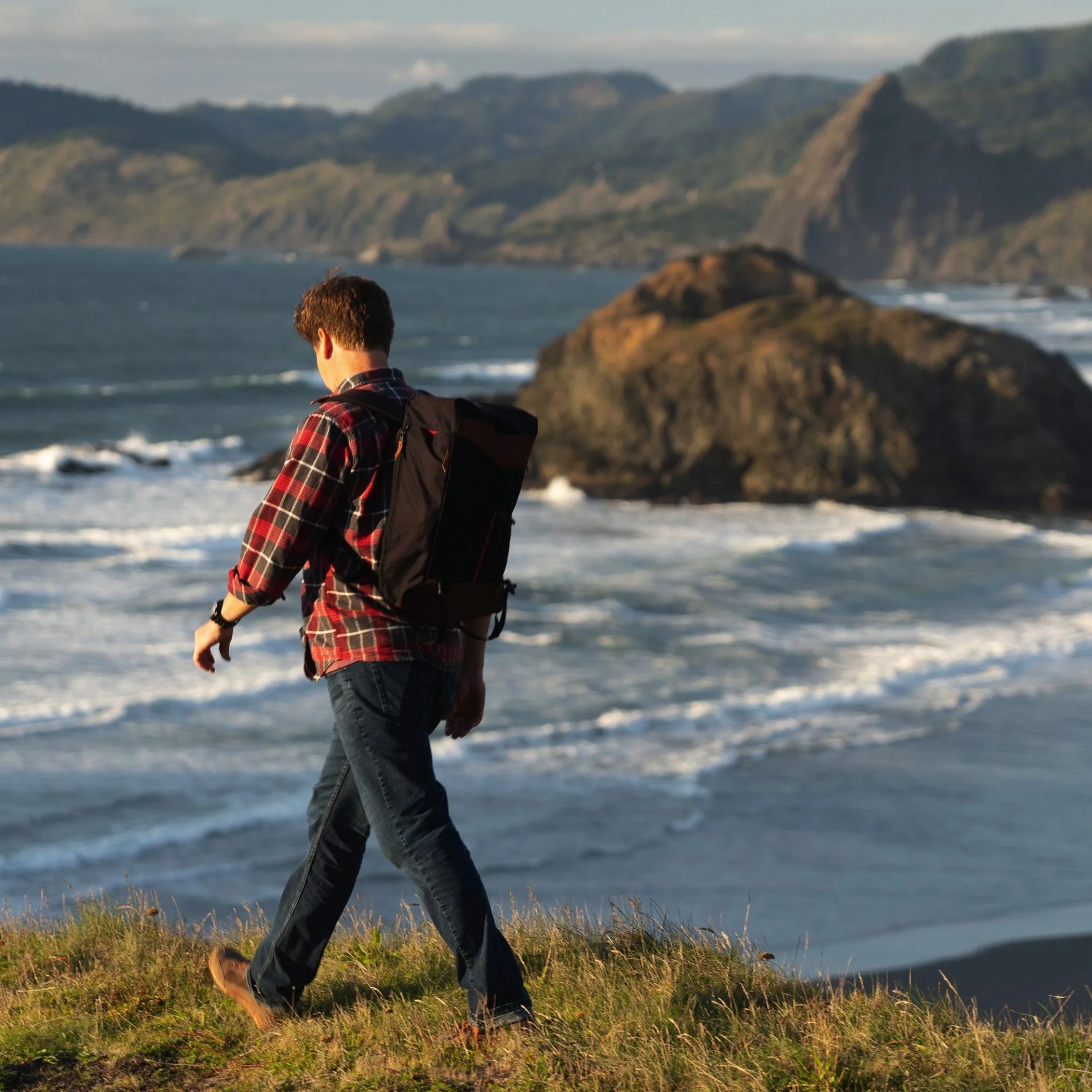 a man hiking near the ocean