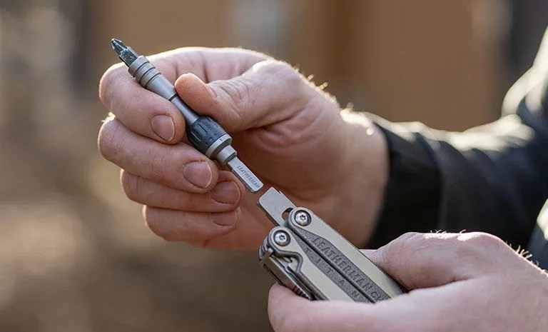hands holding a leatherman multi tool