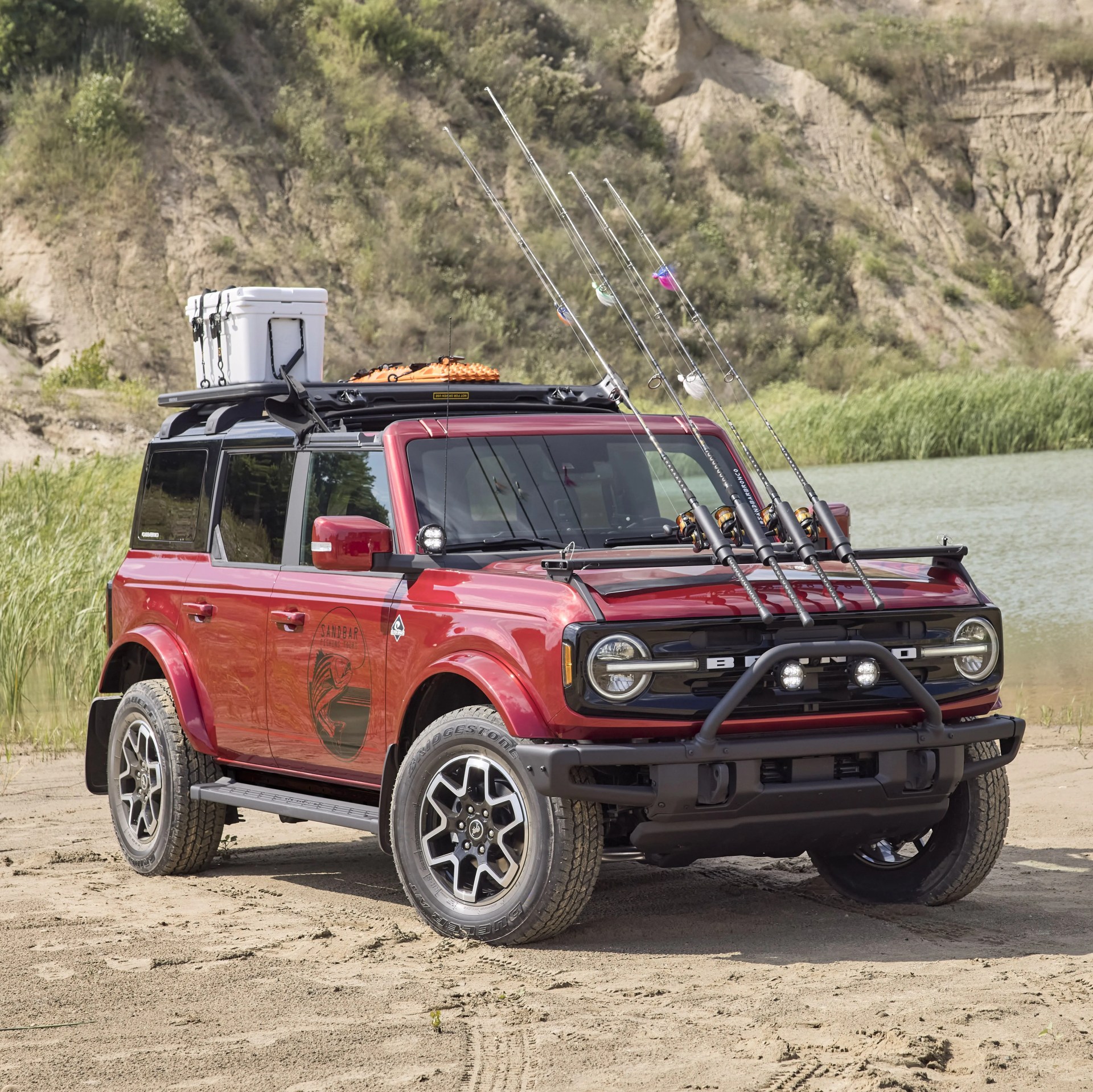 bronco four door outer banks fishing guide purpose built to support a professional fishing guide along cape hatteras national seashore, this lifestyle concept is based off the regionally inspired four door bronco outer banks&trade; series on top is a bestop&reg; sunrider&reg; first row soft top, factory style concept roof rails and crossbars, and a yakima&reg; locknload&trade; platform roof rack the suv makes use of fender mounted trail sights to fit a custom made fishing pole and seat perch to wait for the perfect catch a ford performance modular front bumper and safari bar help push through rugged terrain, while a slide out tailgate provides a great work surface when repairing fishing rods or stringing up new lures all weather floor mats and splash guards round out the package preproduction image with optional features shown available beginning spring 2021 available late 2021