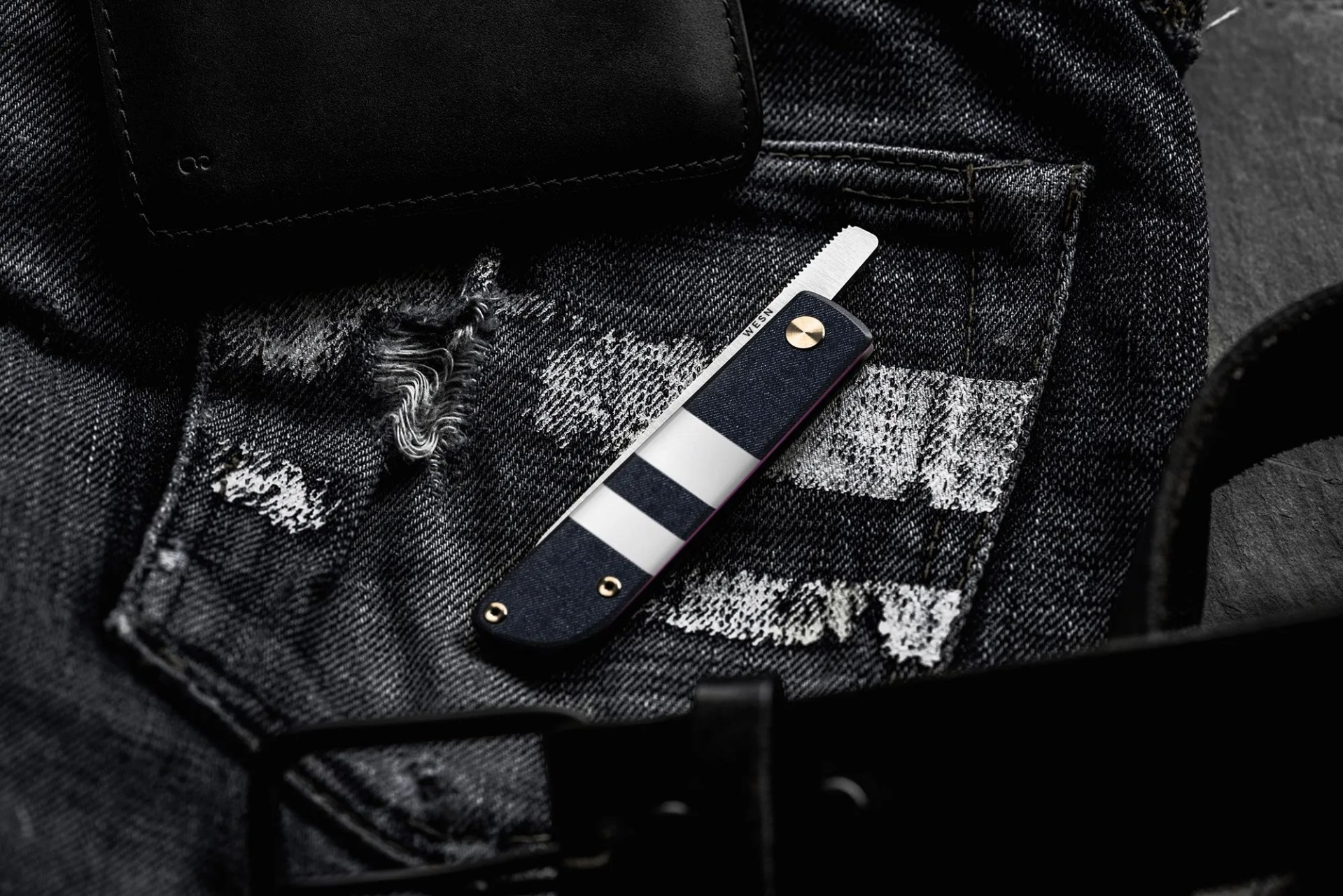 a pocket knife with a denim handle