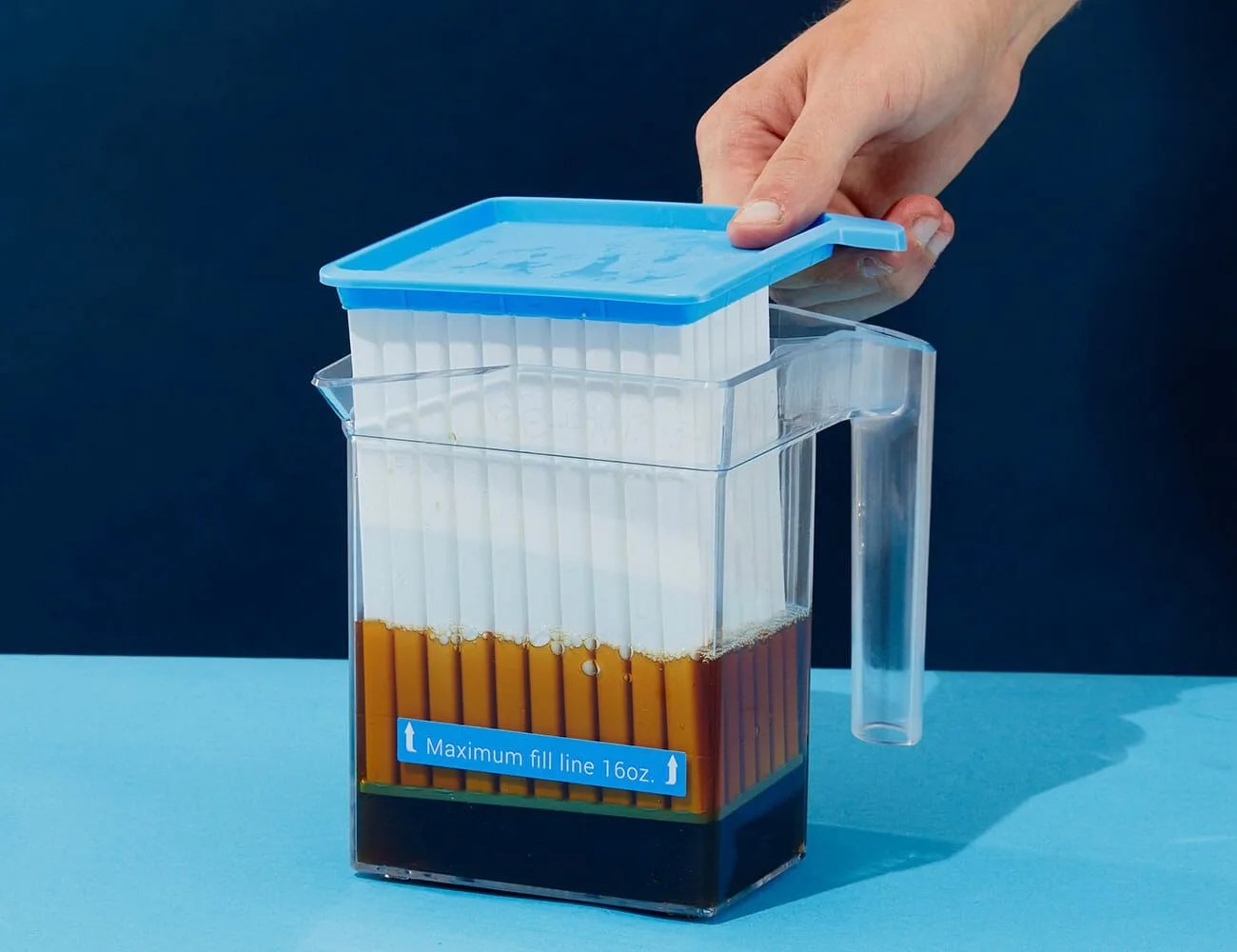 person using a coffee chiller to make iced coffee