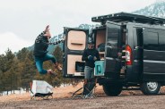 woman and man packing up a campervan