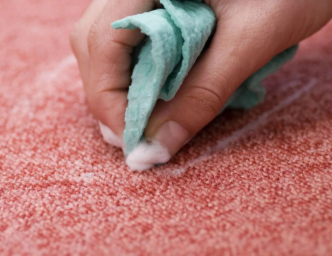 cleaning a red rug